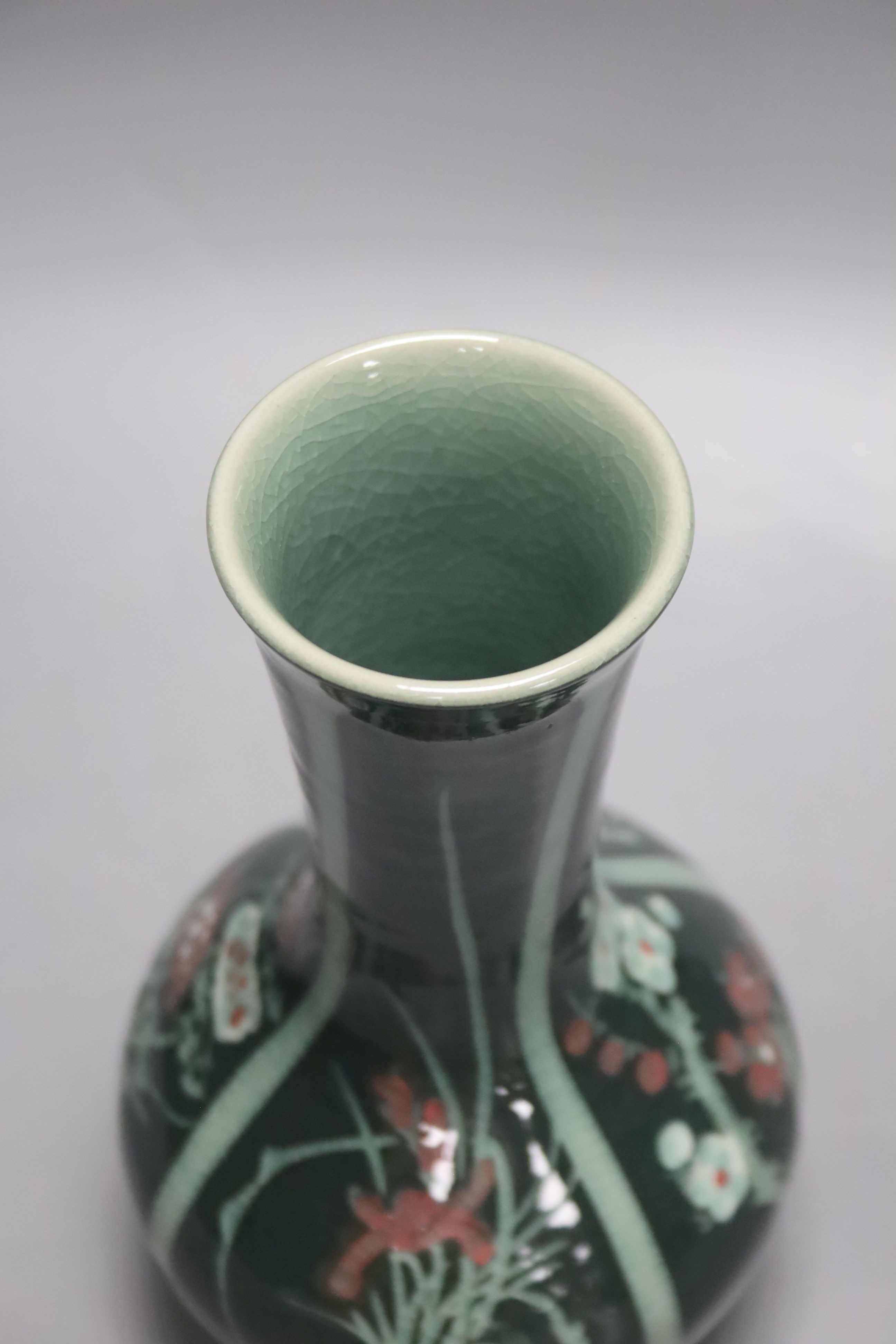 A green Japanese artisan studio vase decorated with flower designs, 20cm tall